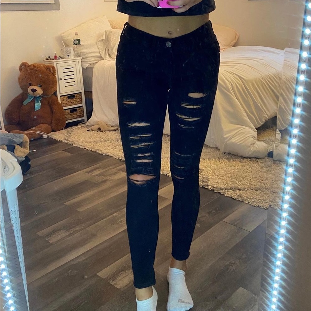 Distressed black skinny jeans